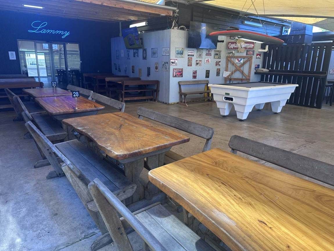 The beer garden with slab timber tables and blue neon